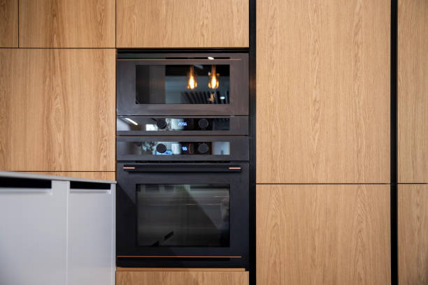 A modern kitchen featuring wooden cabinets, a sleek wall oven, and a functional layout with contemporary design.