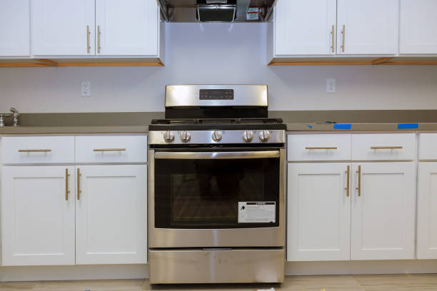 Well-equipped kitchen with a stove, oven, cabinets, shelves, and an over-the-range microwave for space-saving convenience.