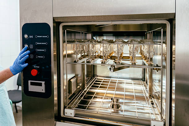 A person in a lab coat holds a tray of food, likely in a setting related to Appliance Installation Services.