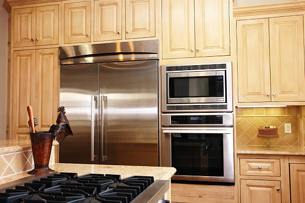 A stylish kitchen equipped with premium stove, oven, and refrigerator, showcasing modern design and functionality.