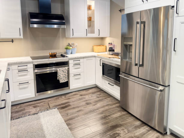 Stylish kitchen with high-end stainless steel appliances and warm wood flooring.