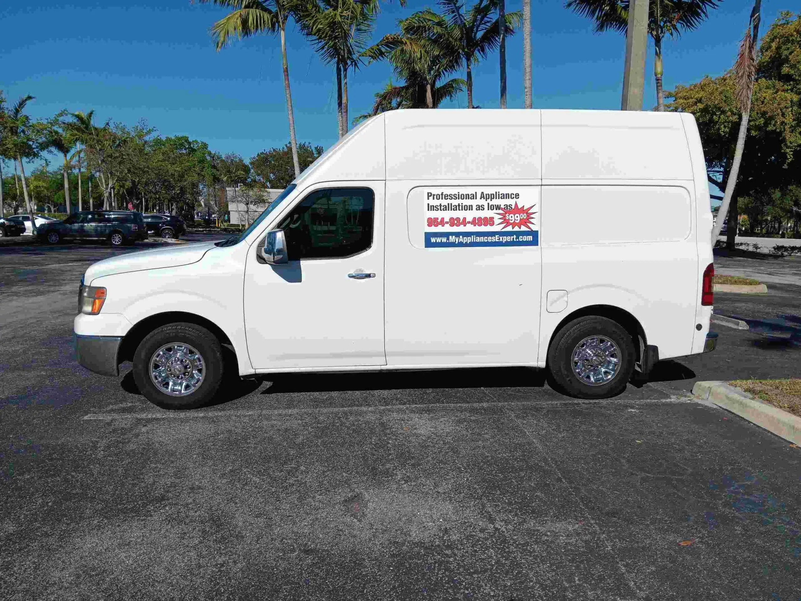Professional appliance installation crew working in kitchen
